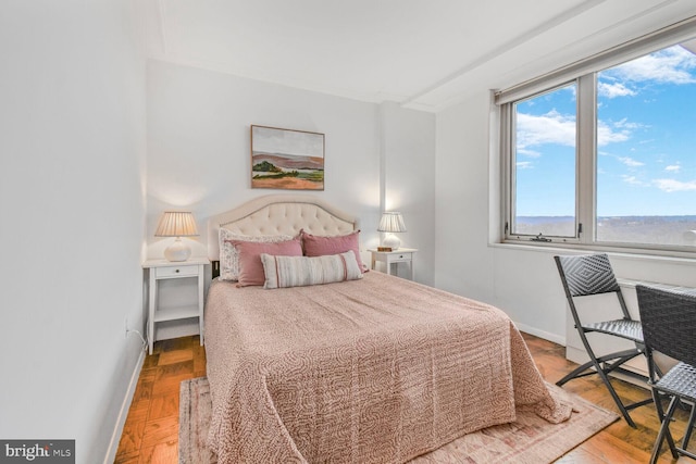 bedroom featuring wood finished floors and baseboards