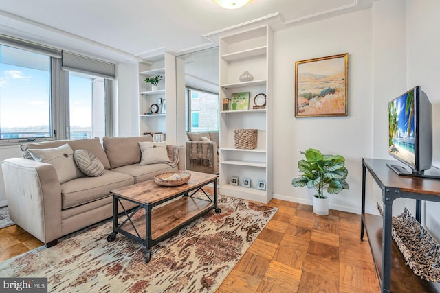 living area featuring baseboards