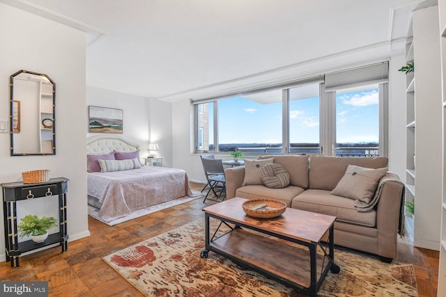 bedroom with a water view and baseboards