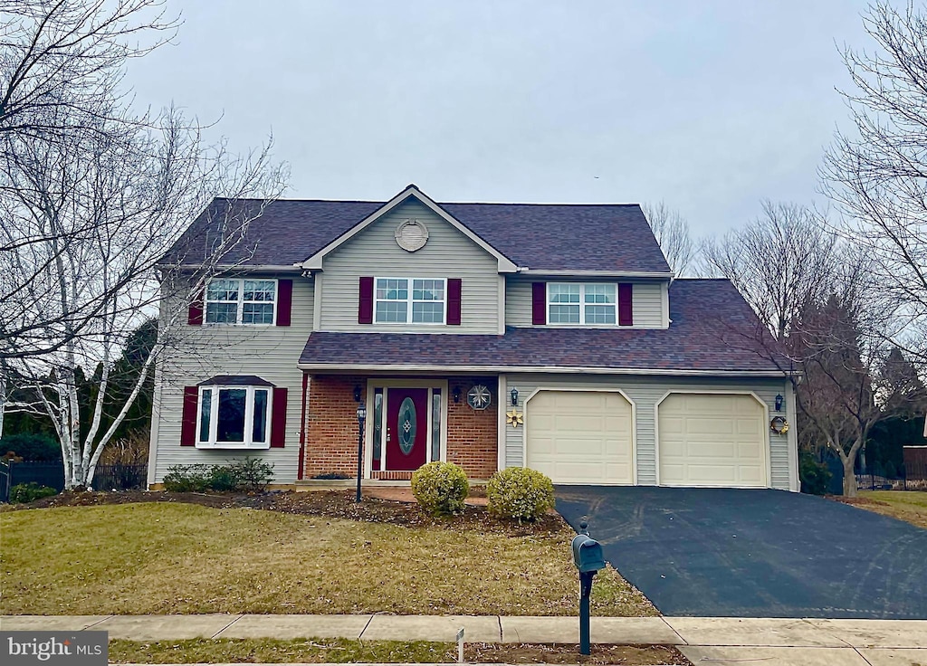 view of front of home featuring a garage and a front lawn