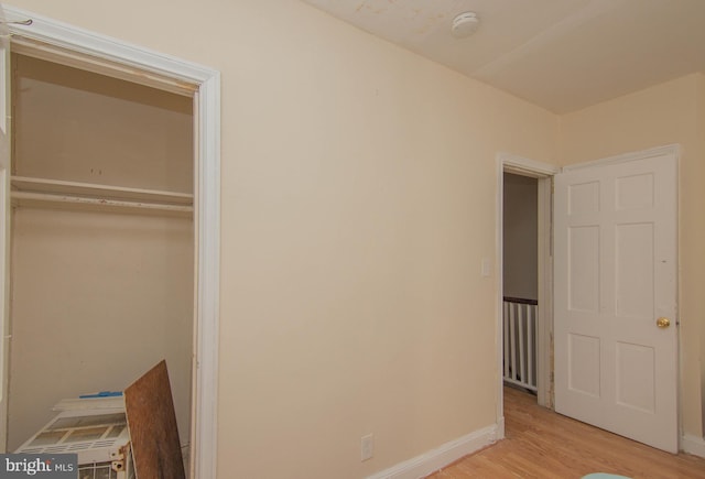 unfurnished bedroom with a closet and light wood-type flooring