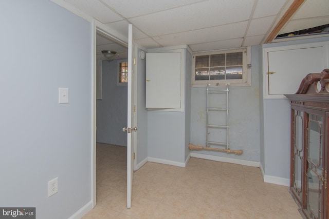 corridor with a paneled ceiling