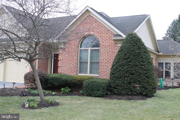 view of side of property with a yard and a garage