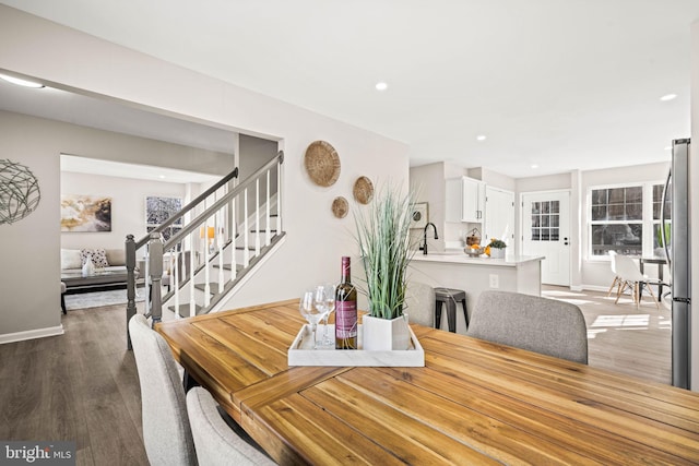 dining room with sink and wood-type flooring