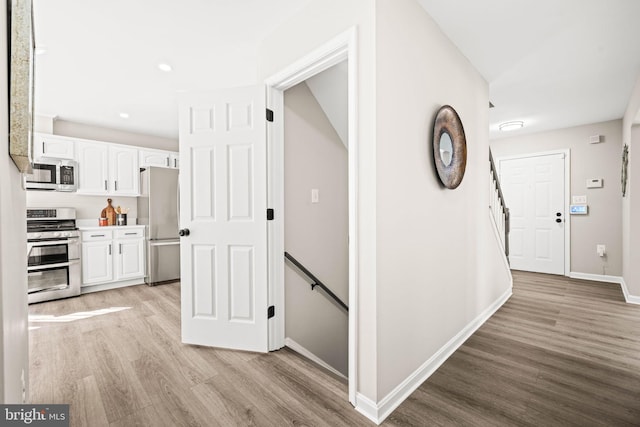 corridor featuring light hardwood / wood-style floors