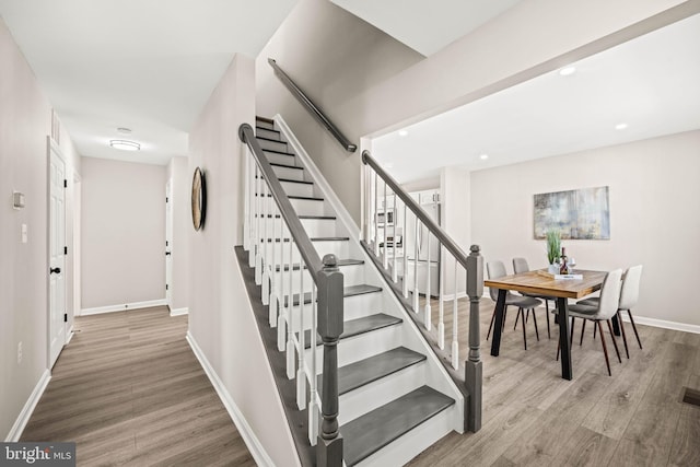 stairs featuring wood-type flooring