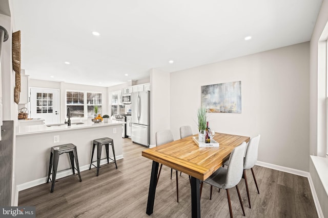 dining area featuring hardwood / wood-style floors and sink