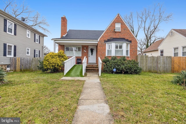 view of front of house with covered porch and a front yard