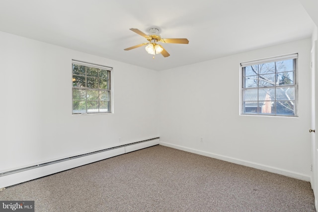 spare room featuring a baseboard heating unit, ceiling fan, carpet, and baseboards