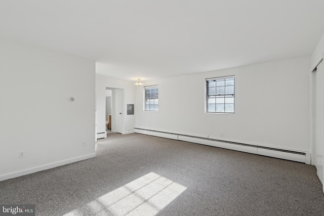 empty room featuring a baseboard radiator, baseboards, baseboard heating, and carpet flooring