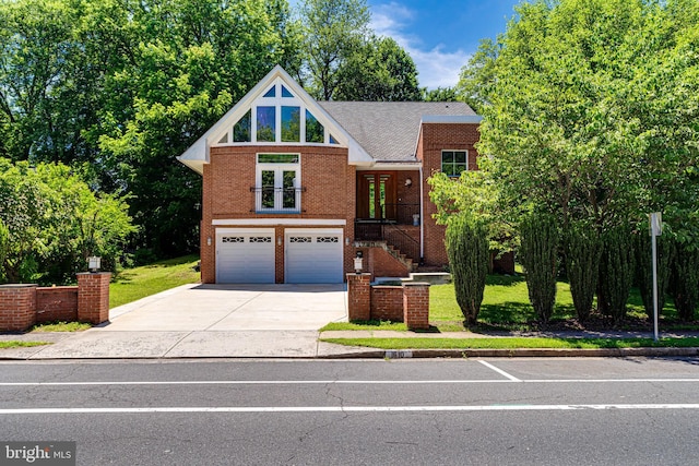 view of front of home featuring a garage, driveway, and brick siding