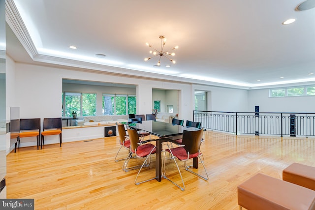 dining room with crown molding, recessed lighting, wood finished floors, and a notable chandelier