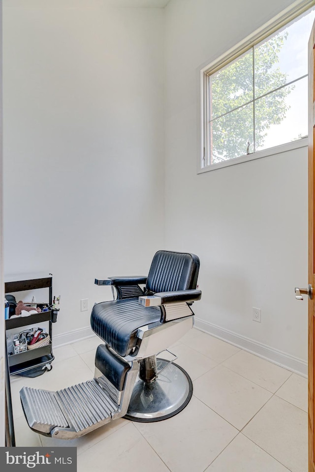 sitting room with light tile patterned flooring and baseboards