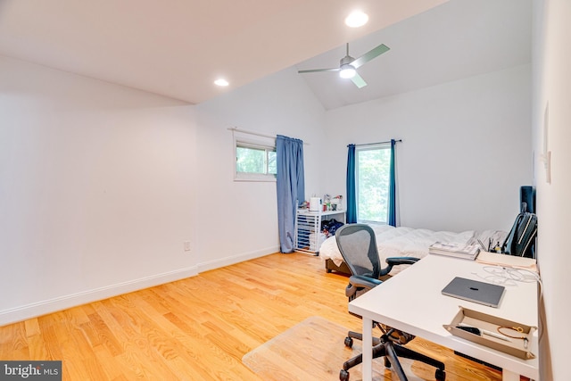 home office with lofted ceiling, ceiling fan, baseboards, and wood finished floors