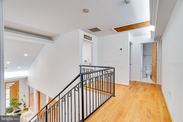 hallway featuring recessed lighting, visible vents, attic access, light wood-style floors, and an upstairs landing