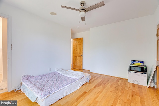 bedroom featuring ceiling fan and wood finished floors