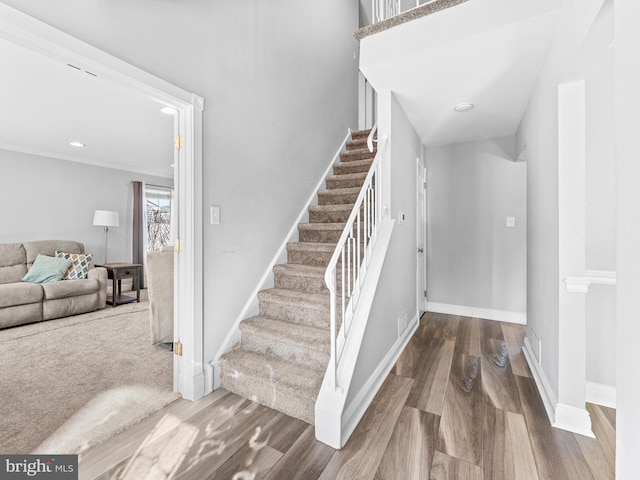 stairway with recessed lighting, wood finished floors, and baseboards