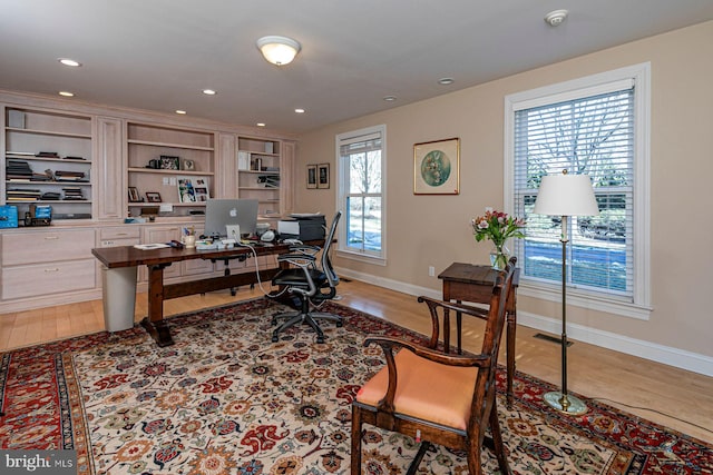 office space with light wood finished floors, baseboards, visible vents, and recessed lighting