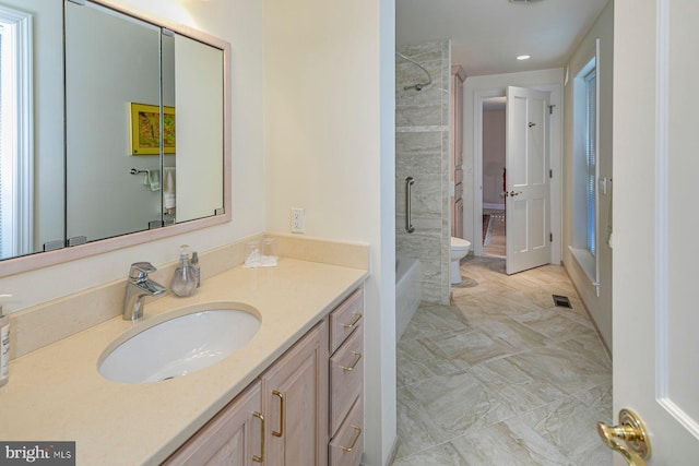 bathroom featuring visible vents, vanity, toilet, and bathing tub / shower combination