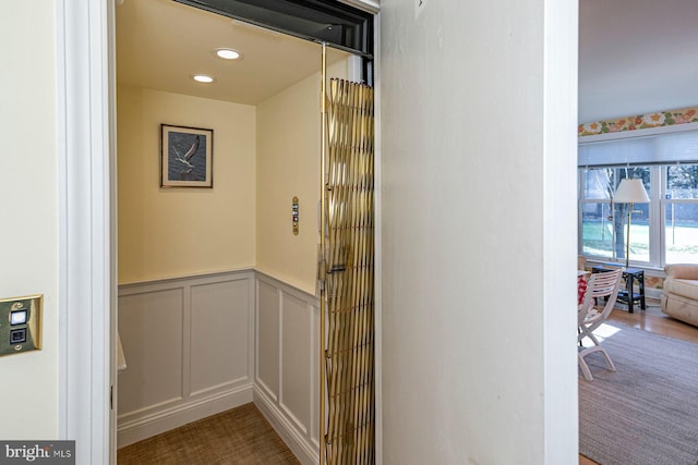 interior details featuring a wainscoted wall, a decorative wall, and recessed lighting