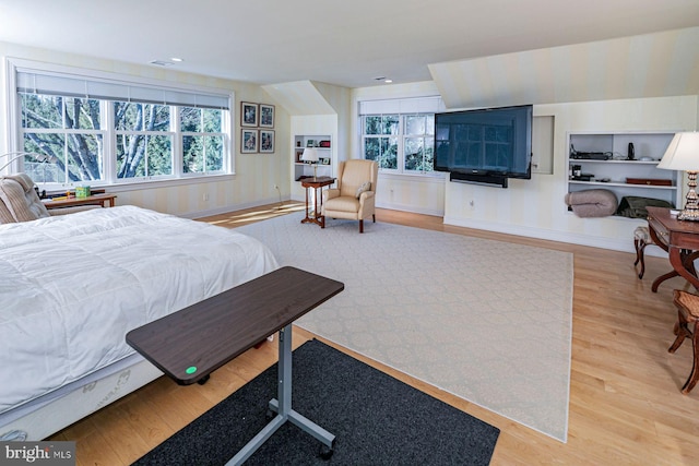 bedroom with baseboards and wood finished floors