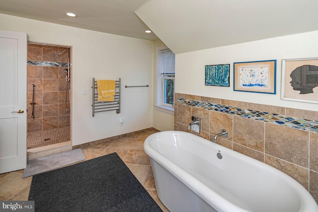 bathroom featuring recessed lighting, a freestanding bath, and a shower stall