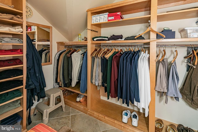 spacious closet featuring vaulted ceiling and tile patterned floors