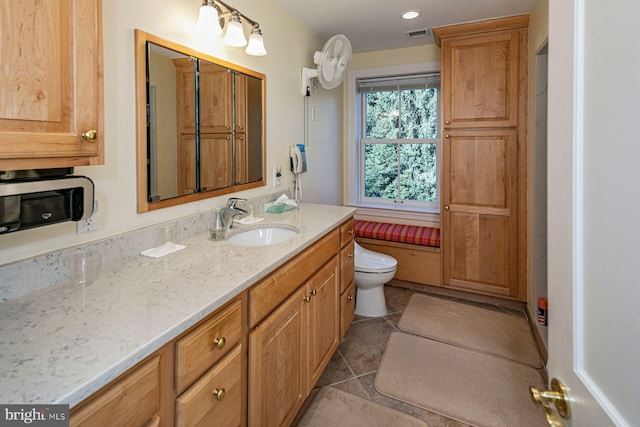 bathroom with vanity and toilet