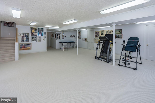 workout room with carpet flooring and a textured ceiling