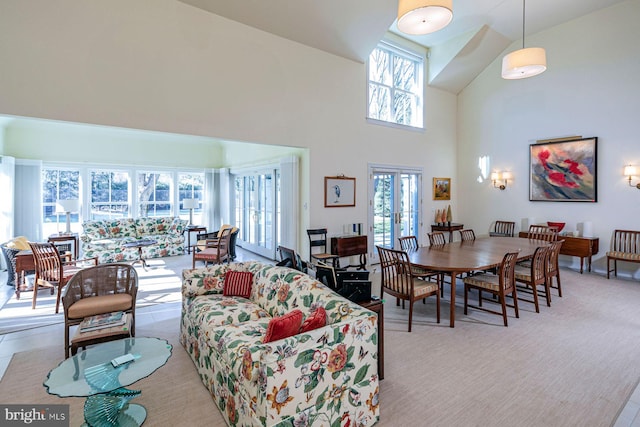 living room with carpet, french doors, and a towering ceiling