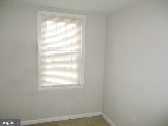 unfurnished room with light carpet