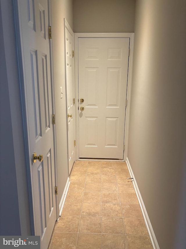 entryway featuring light tile patterned floors and baseboards