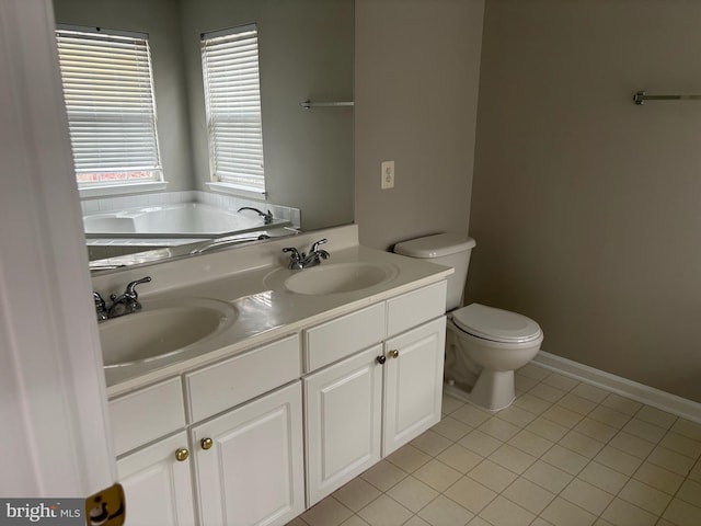 full bathroom featuring toilet, tile patterned flooring, double vanity, and a sink