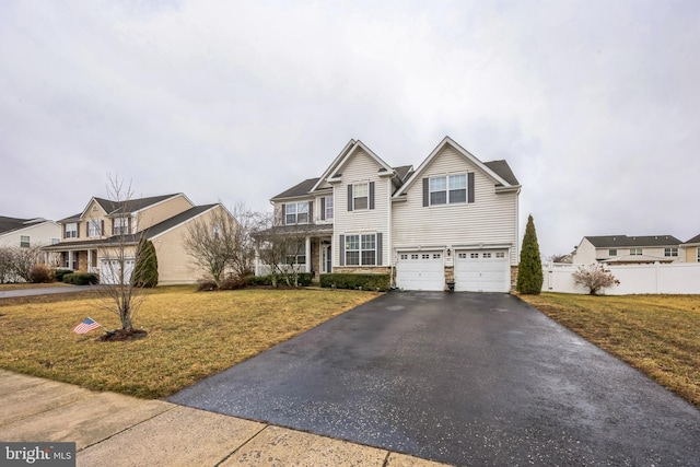 view of front property featuring a garage and a front lawn