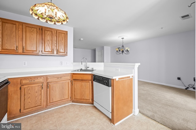 kitchen featuring a peninsula, a sink, a chandelier, white dishwasher, and light countertops