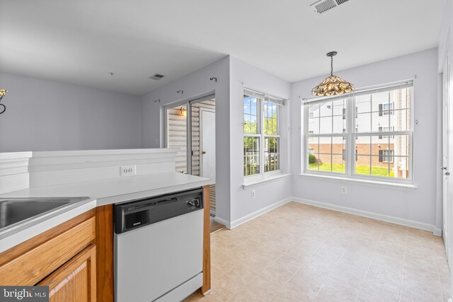 kitchen with white dishwasher, a chandelier, light countertops, baseboards, and visible vents