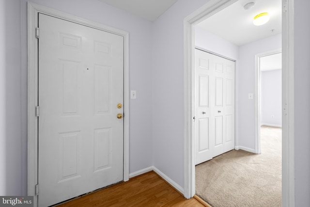 entryway with wood finished floors and baseboards