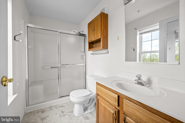 bathroom featuring a shower stall, marble finish floor, vanity, and toilet