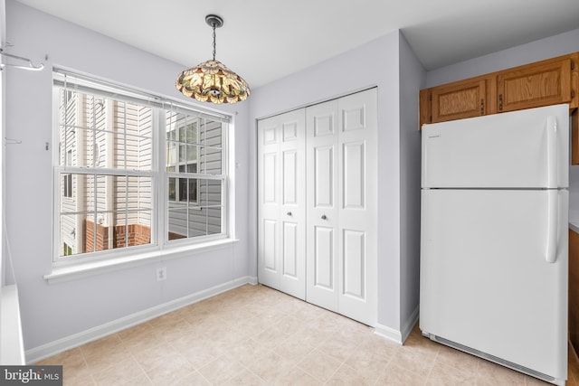 unfurnished dining area featuring baseboards