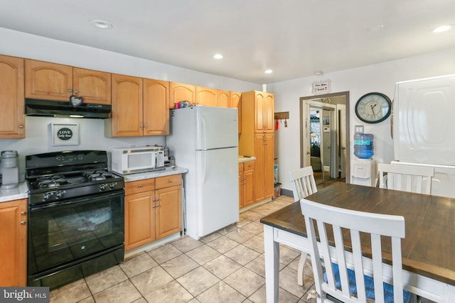 kitchen featuring light tile patterned floors and white appliances