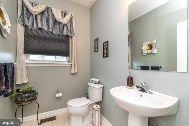 bathroom with sink, tile patterned floors, and toilet