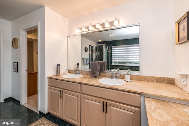 bathroom with vanity, a shower with door, and tile patterned floors