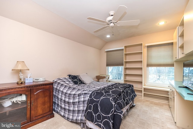 bedroom featuring multiple windows, vaulted ceiling, and light carpet