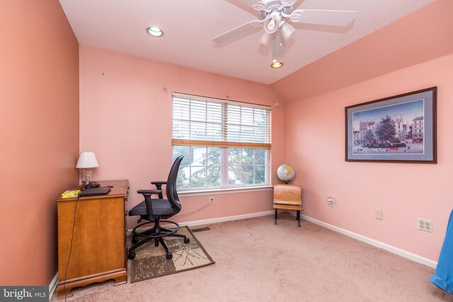 home office featuring lofted ceiling, light carpet, and ceiling fan