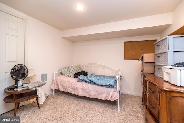 bedroom featuring light carpet