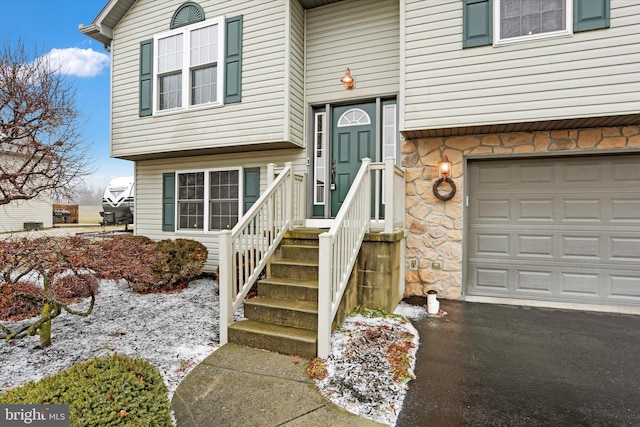 view of exterior entry with a garage