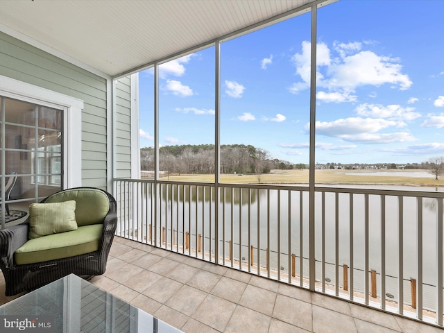 sunroom / solarium with a water view