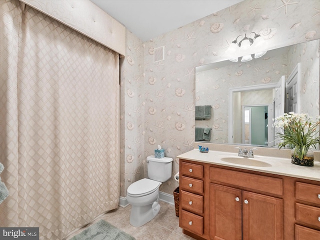 bathroom with vanity, tile patterned floors, and toilet