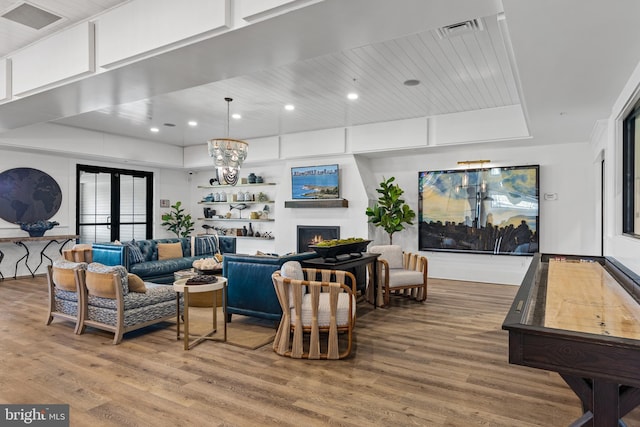 living room featuring hardwood / wood-style floors, wooden ceiling, and french doors