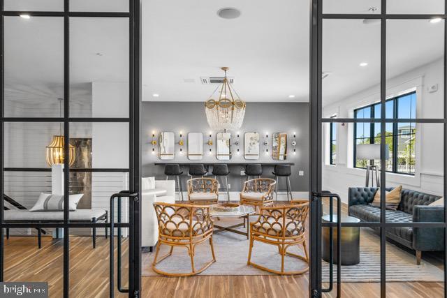 dining area with an inviting chandelier and hardwood / wood-style floors